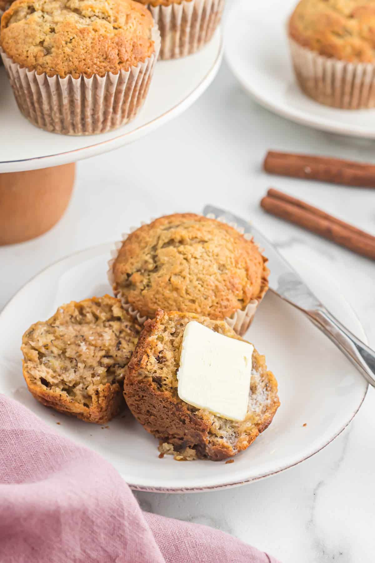 banana bread muffin cut in half with butter melting on it