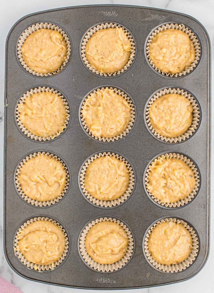 muffin tin filled with banana bread batter