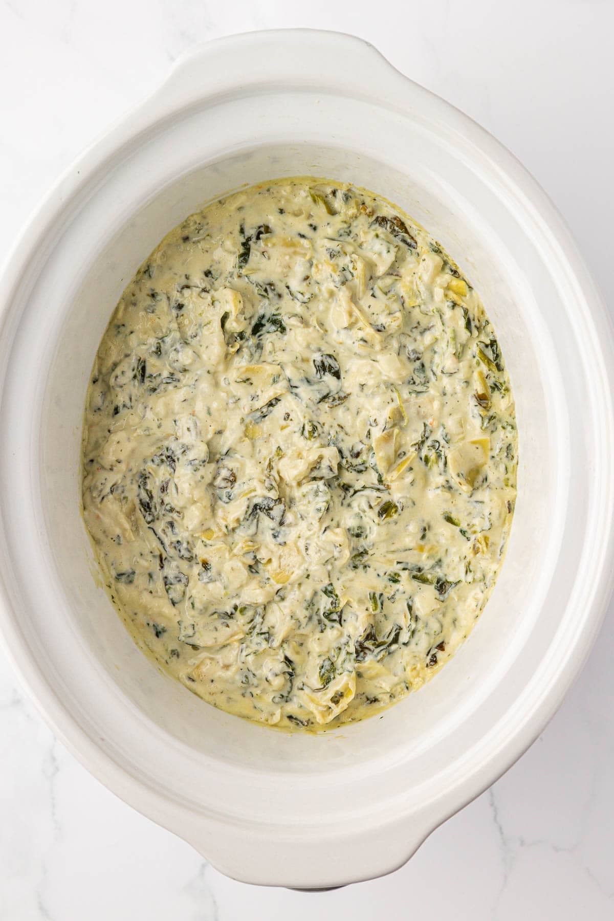 spinach artichoke dip in a slow cooker