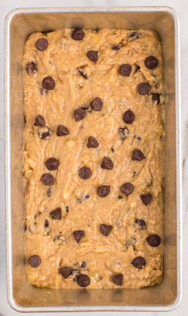 loaf pan with chocolate chip banana bread batter in it