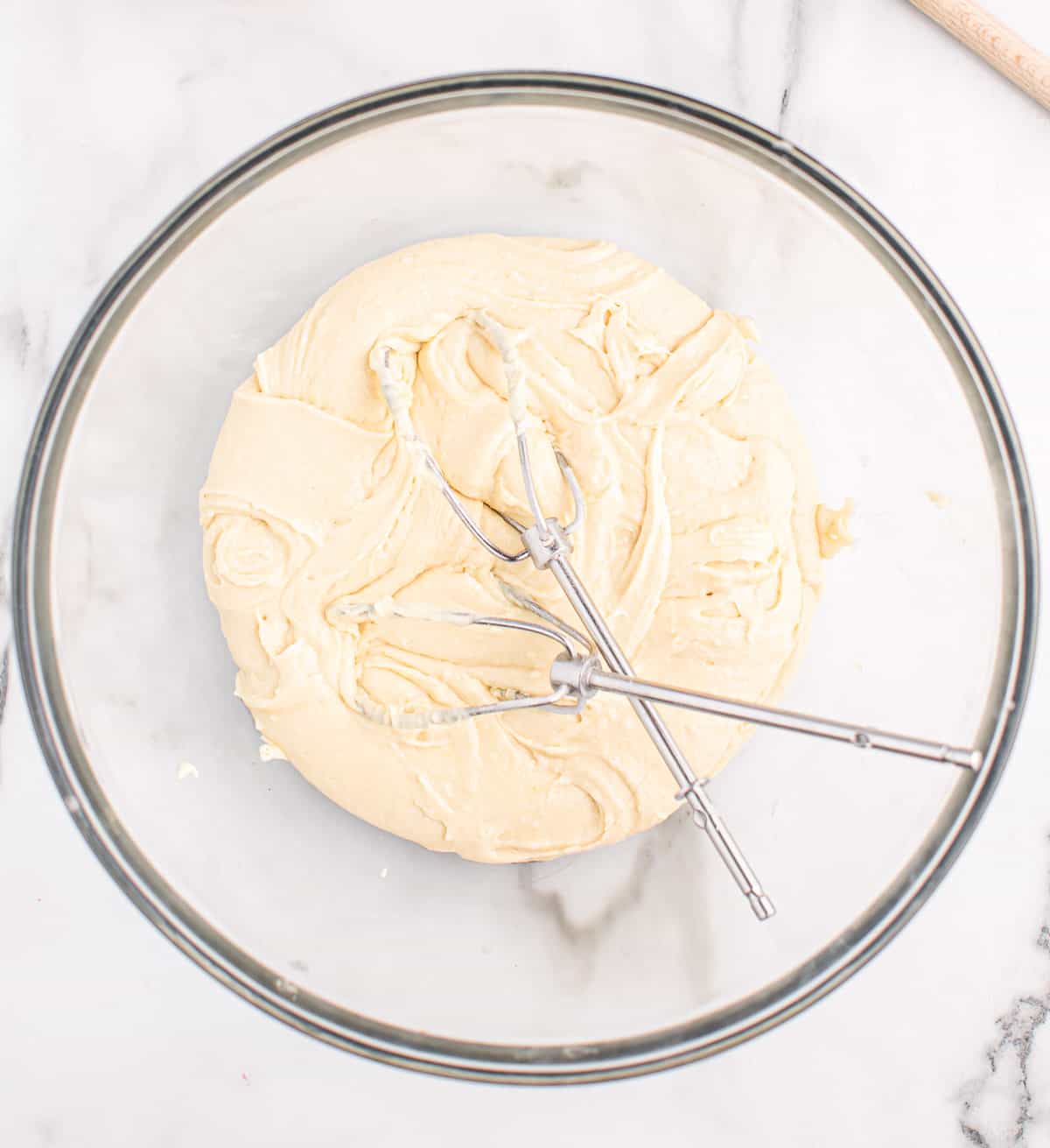 white cake mix batter mixed together in a bowl