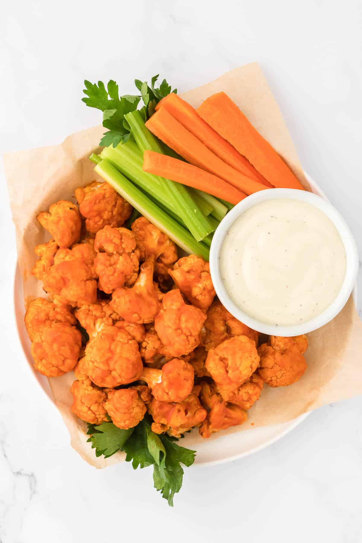 buffalo cauliflower bites with celery, carrots, and ranch