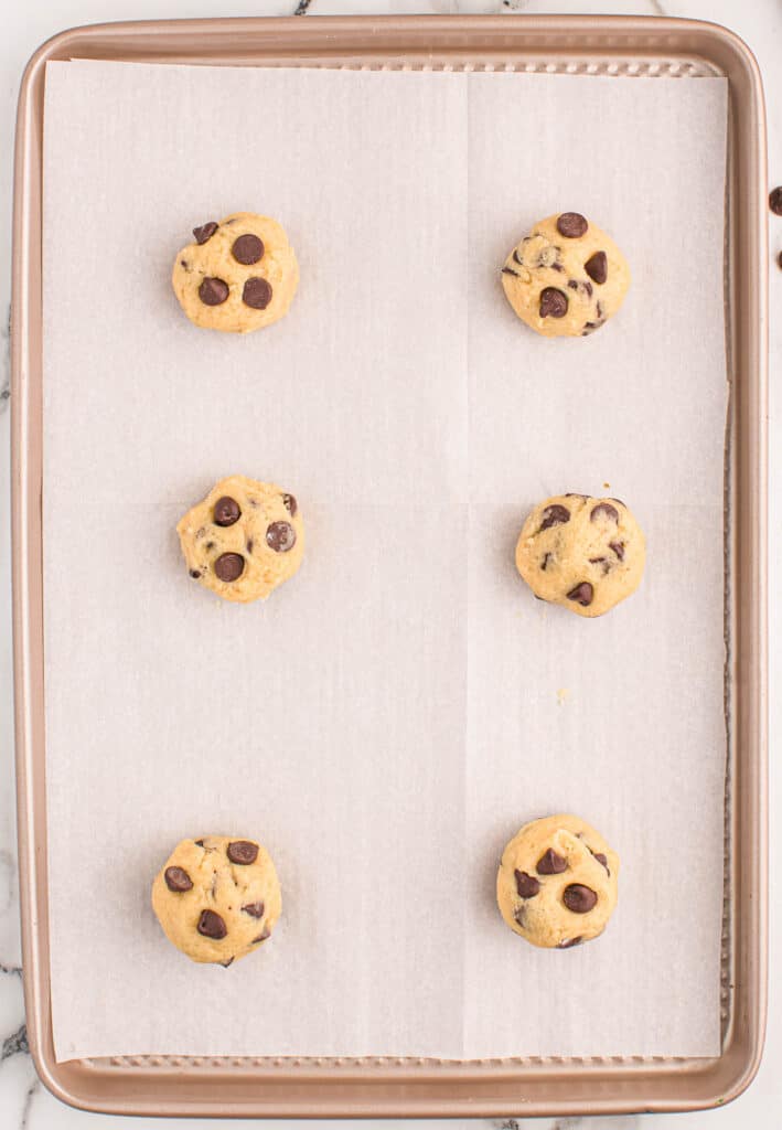chocolate chip cookie dough batter on a baking sheet
