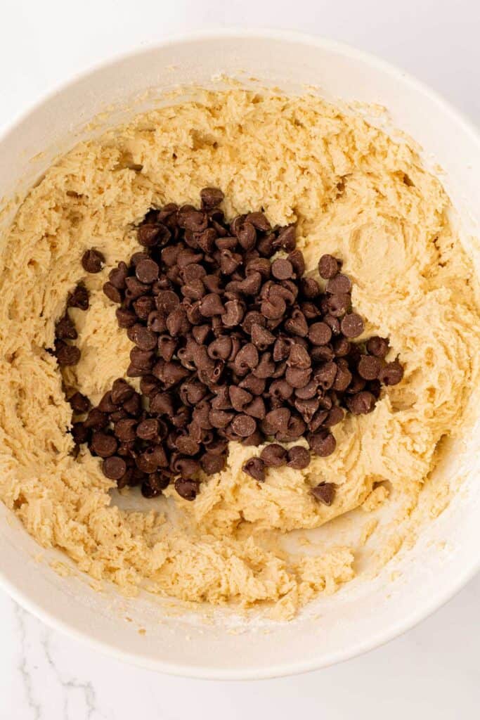 adding chocolate chips to the cookie dough