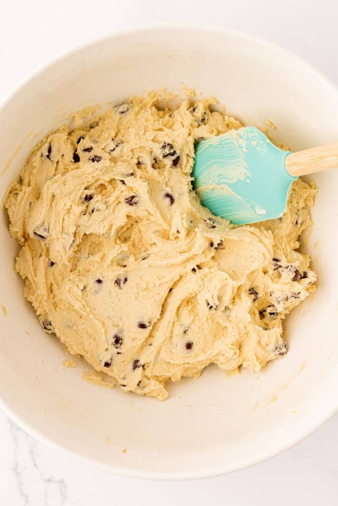 chocolate chip cookie dough mixed together with a rubber spatula