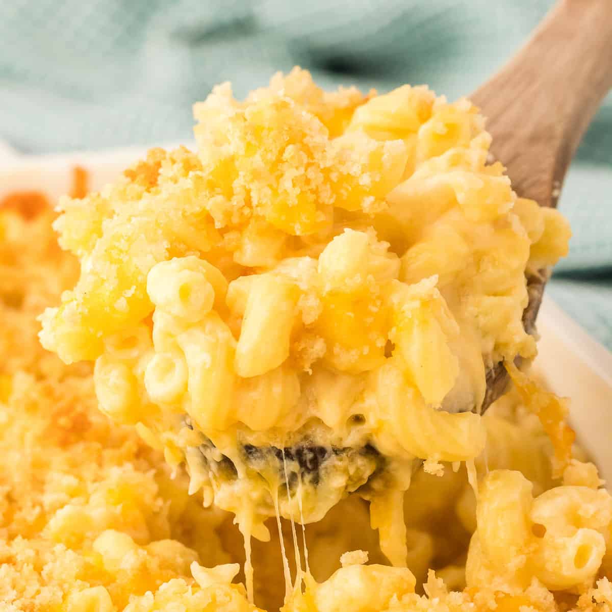scooping mac and cheese from the baking dish