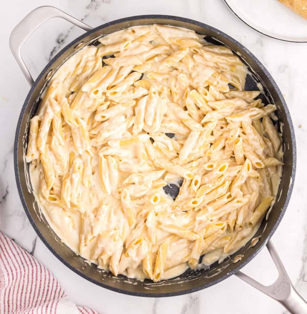 creamy penne pasta in a skillet