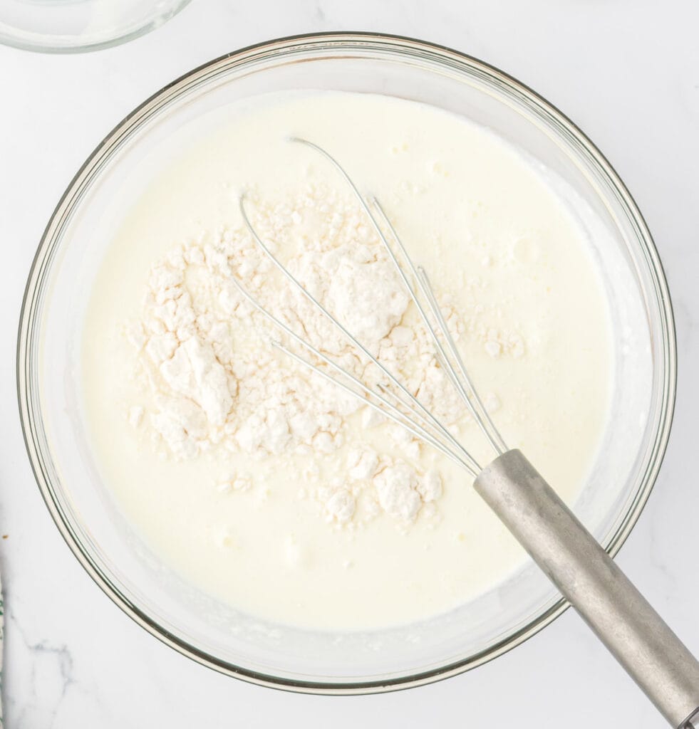 milk, heavy cream, and flour in a bowl