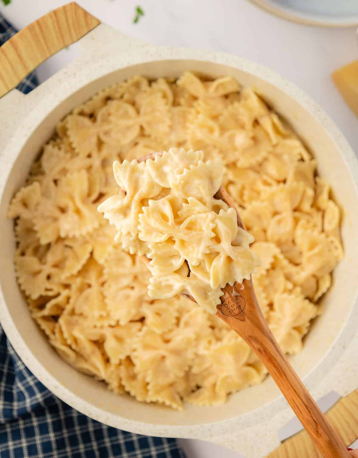 wooden spoon with bow tie pasta