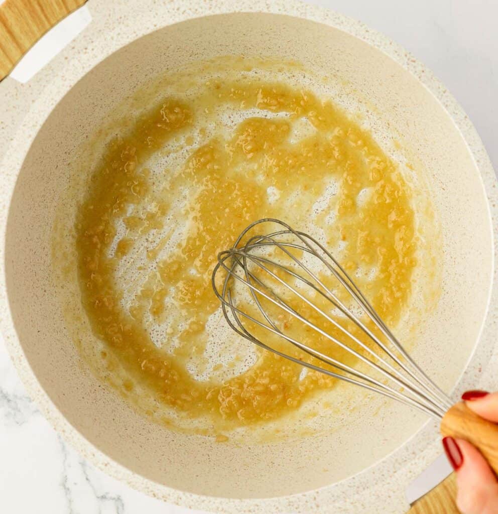 whisking flour into the butter and garlic