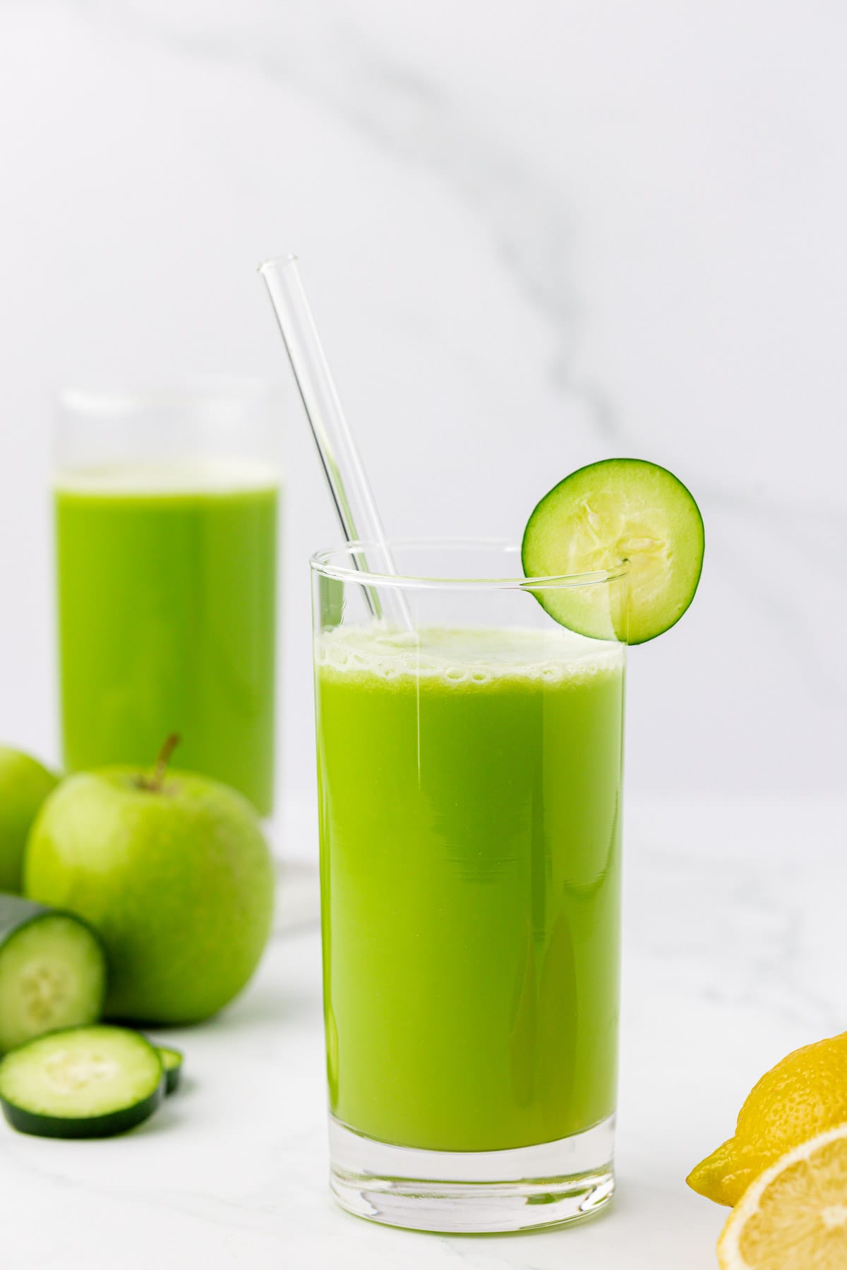 juice in a glass with a cucumber slice on the rim