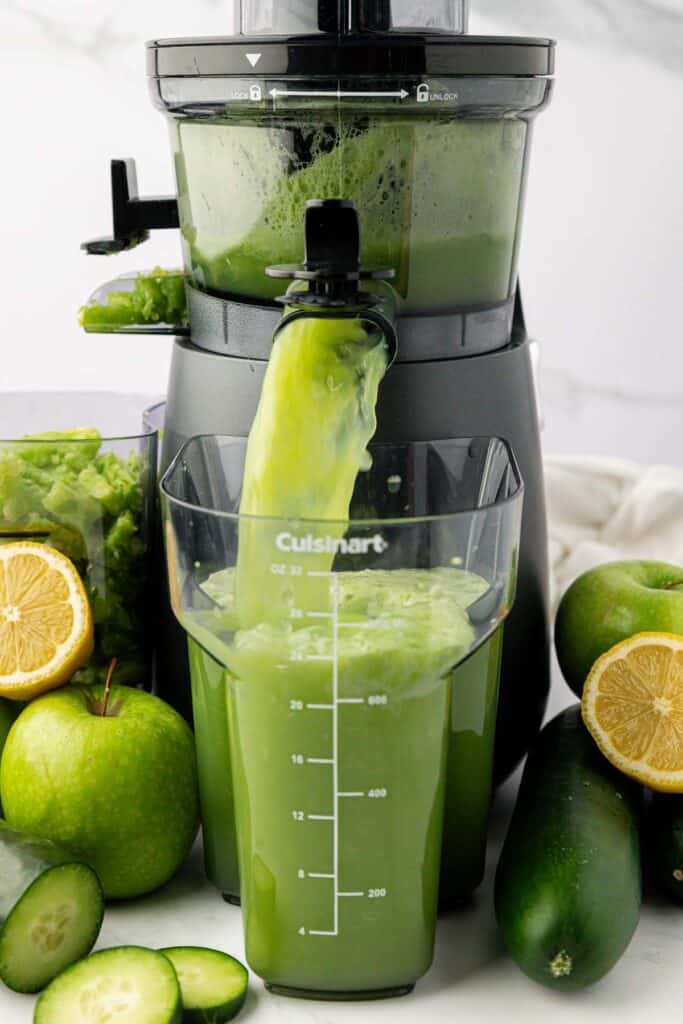 cucumber juice coming out of a juicer