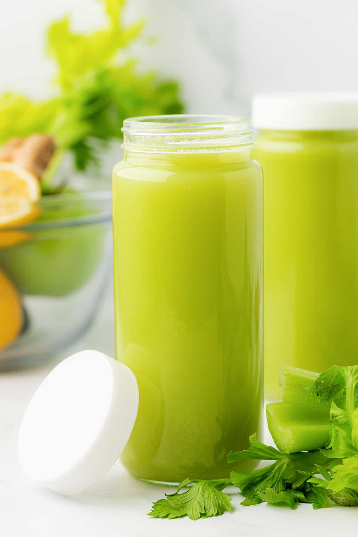 celery juice in a glass with a lid