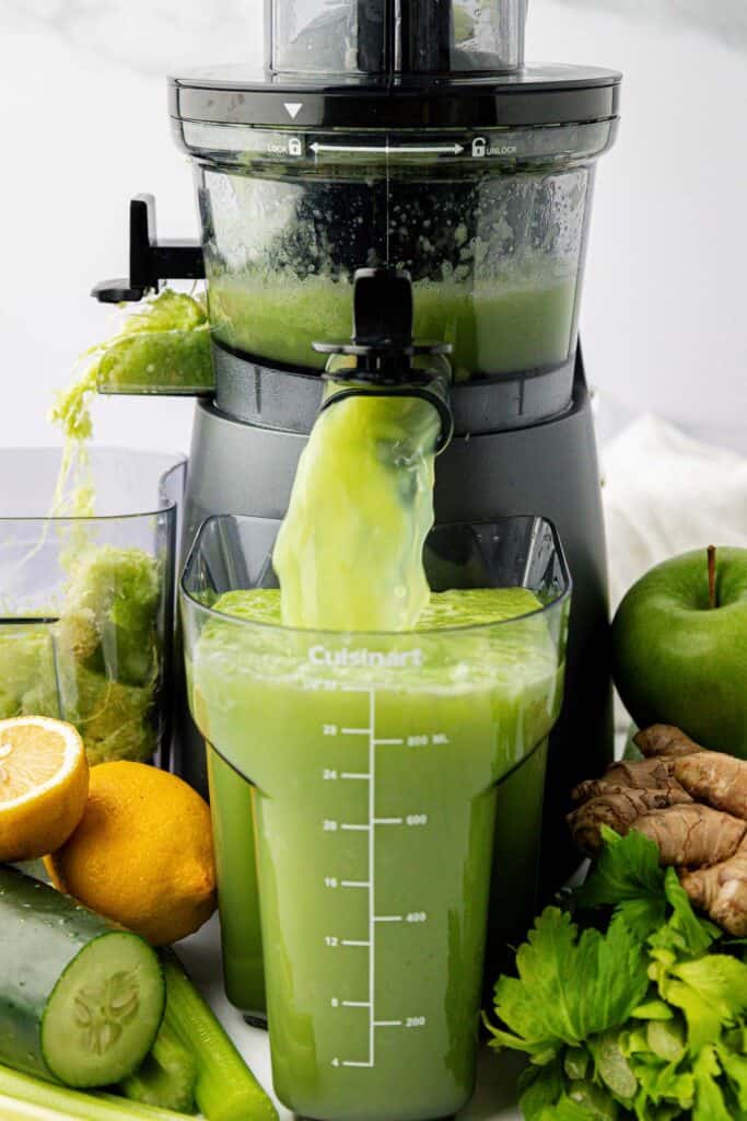 celery juice coming out of a juicer
