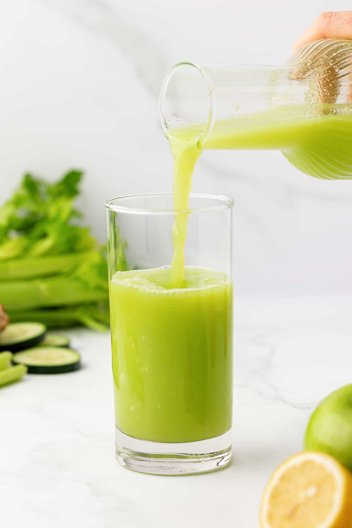 pouring celery juice into a glass