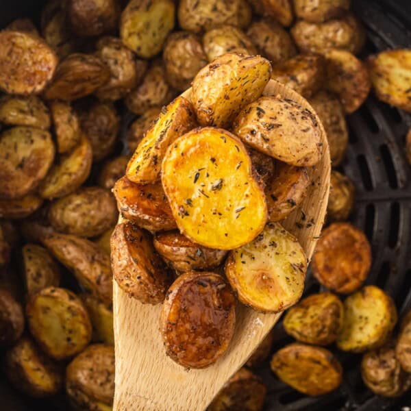 air fryer baby potatoes on a wooden spoon