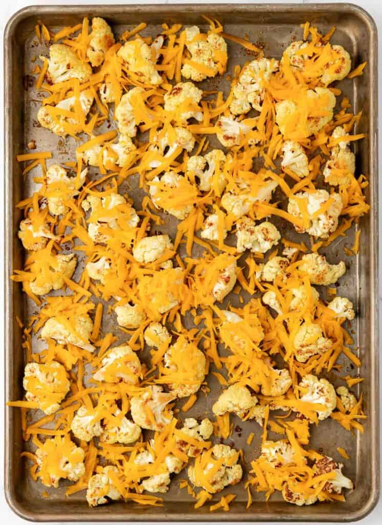 adding cheese to the roasted cauliflower
