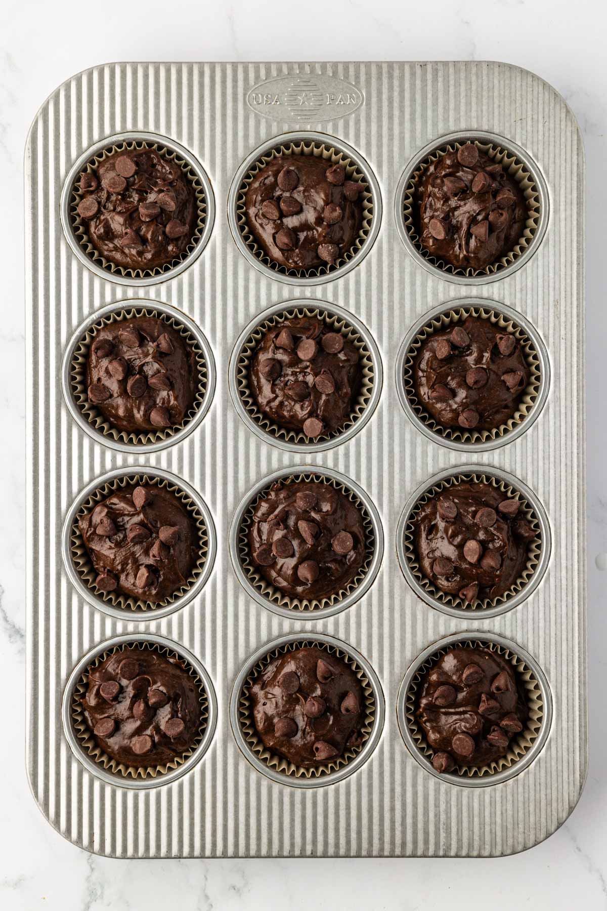 muffin tin filled with cake mix batter