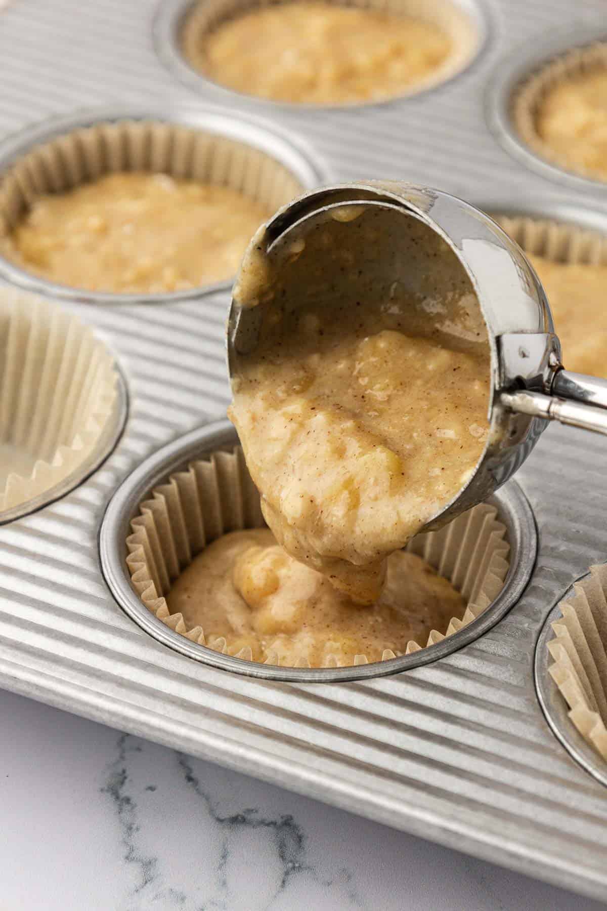 pouring batter into a muffin tin