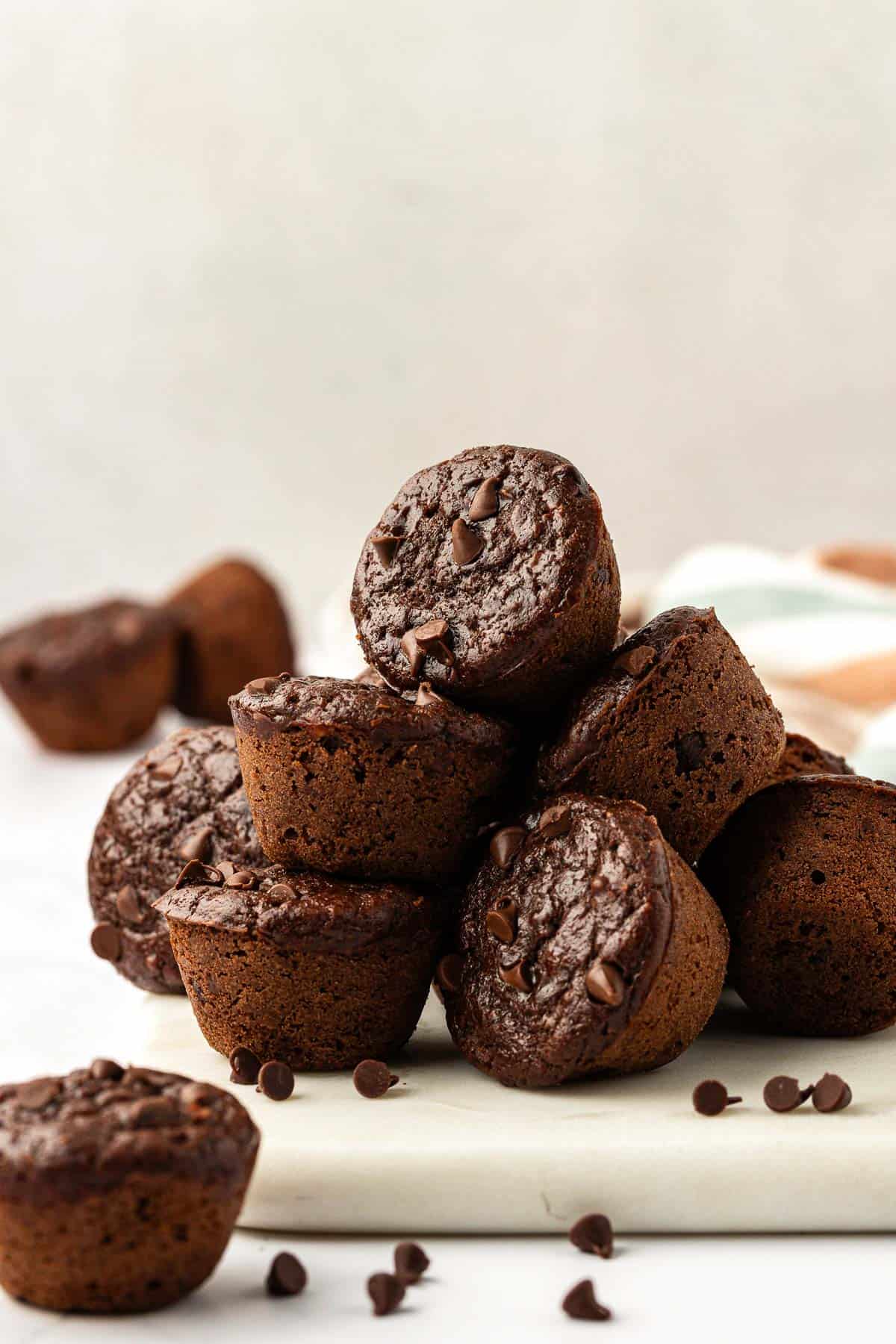 healthy chocolate mini muffins stacked on top of each other