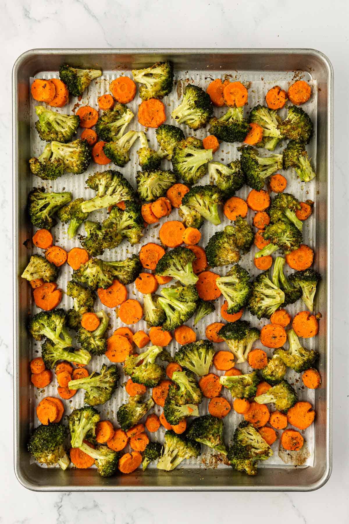 roasted broccoli and carrots on a baking sheet