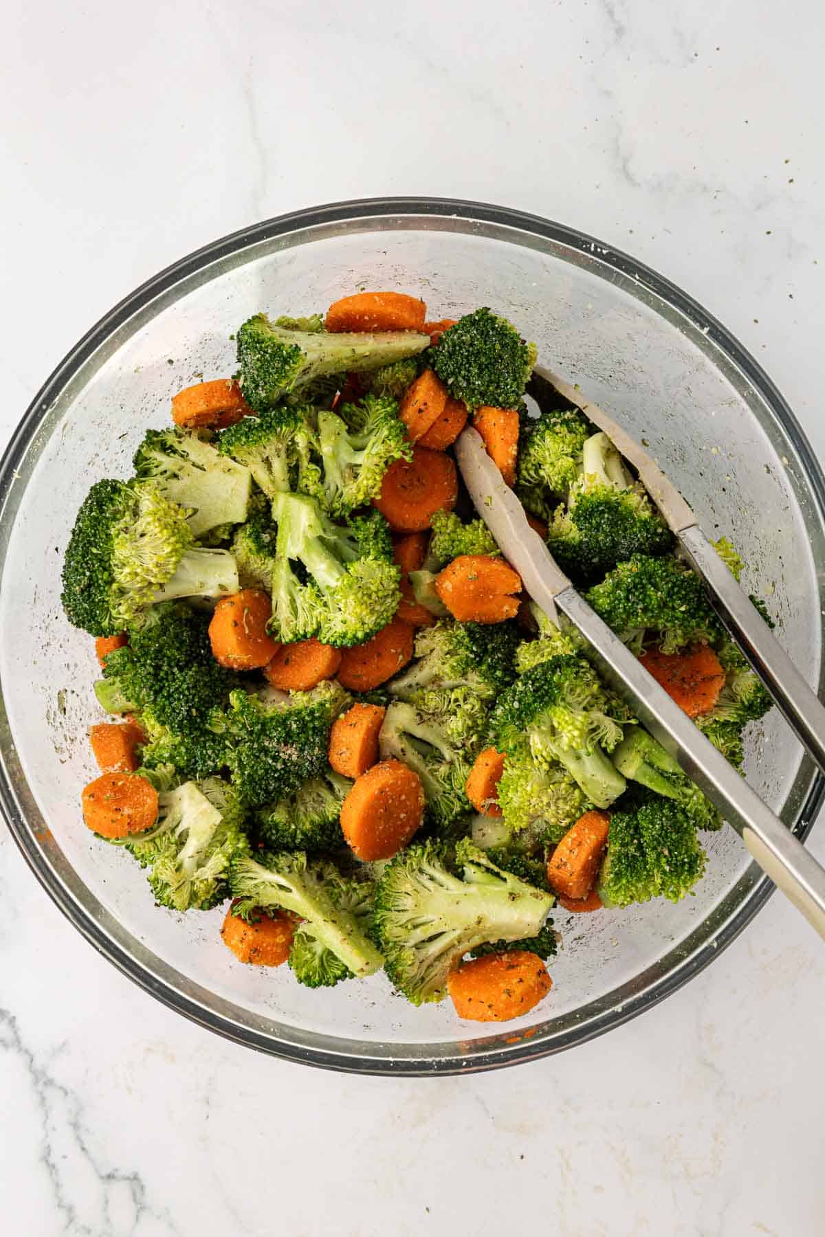 broccoli and carrots mixed together with the spices and parmesan cheese