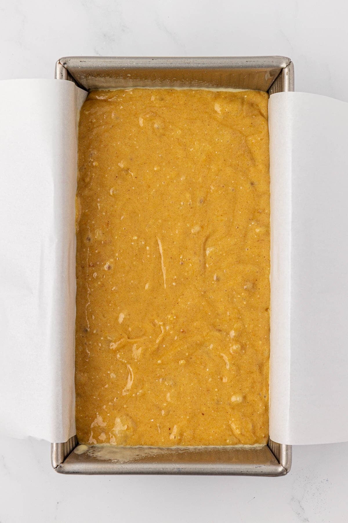 banana bread batter in a loaf pan