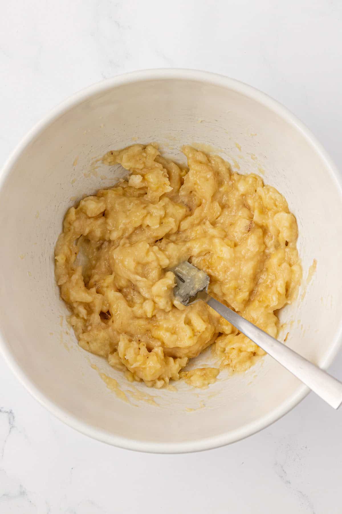 mashed bananas in a mixing bowl
