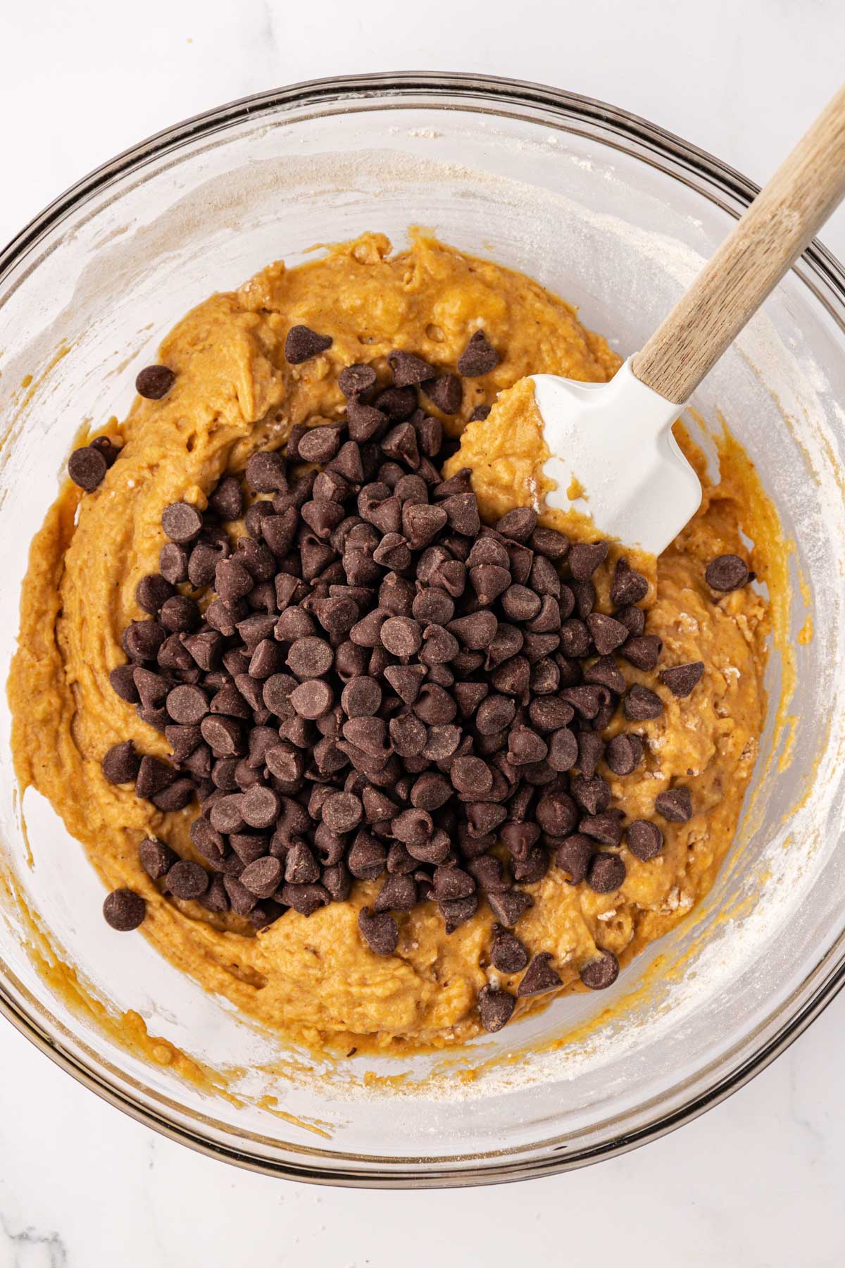 adding chocolate chips to the batter