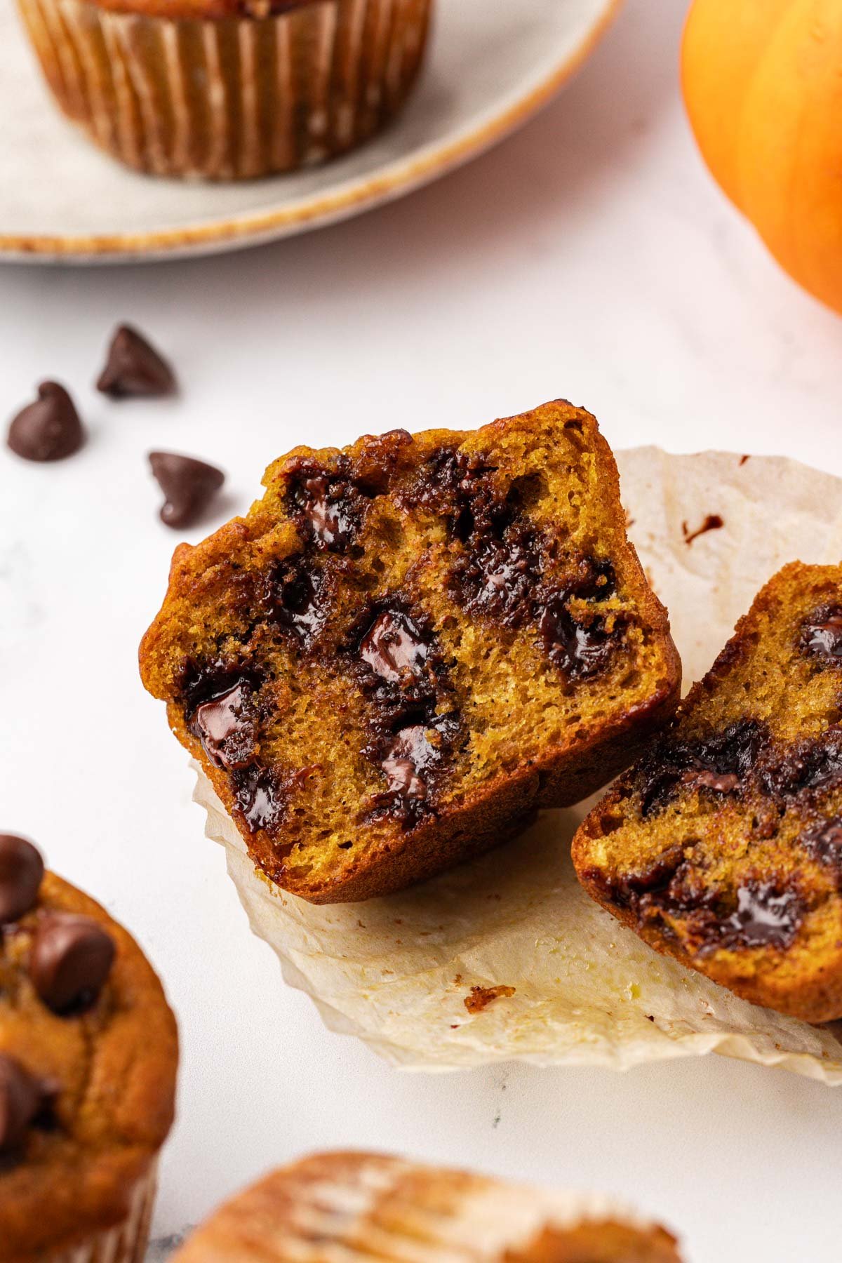 pumpkin chocolate chip muffin cut in half to show the inside