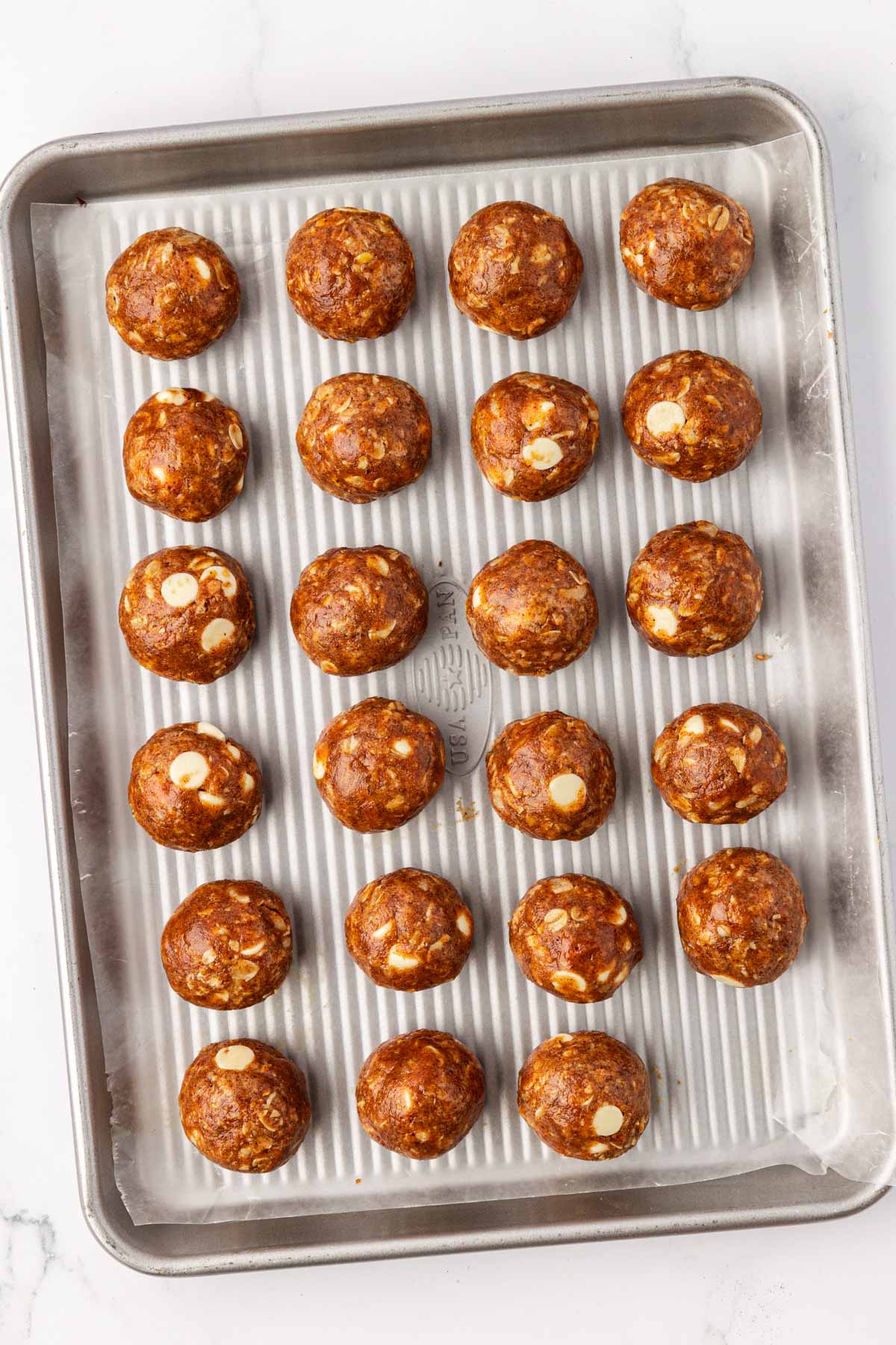 White Chocolate Pumpkin Spice Energy Bites on a baking sheet