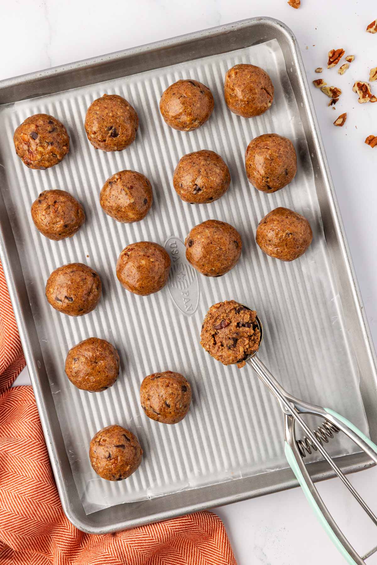 scooping batter onto a baking sheet