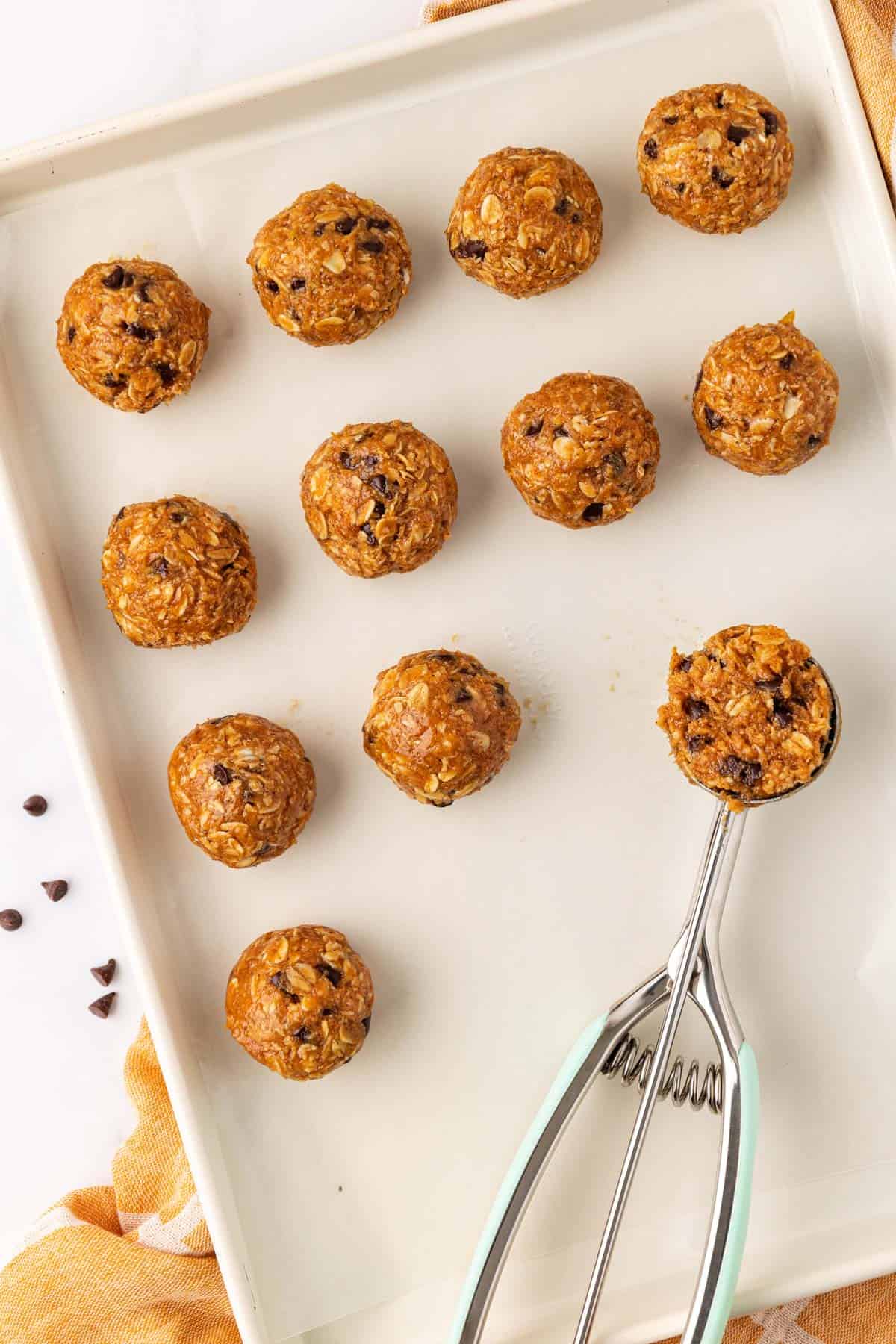 baking sheet with a scoop and energy bites