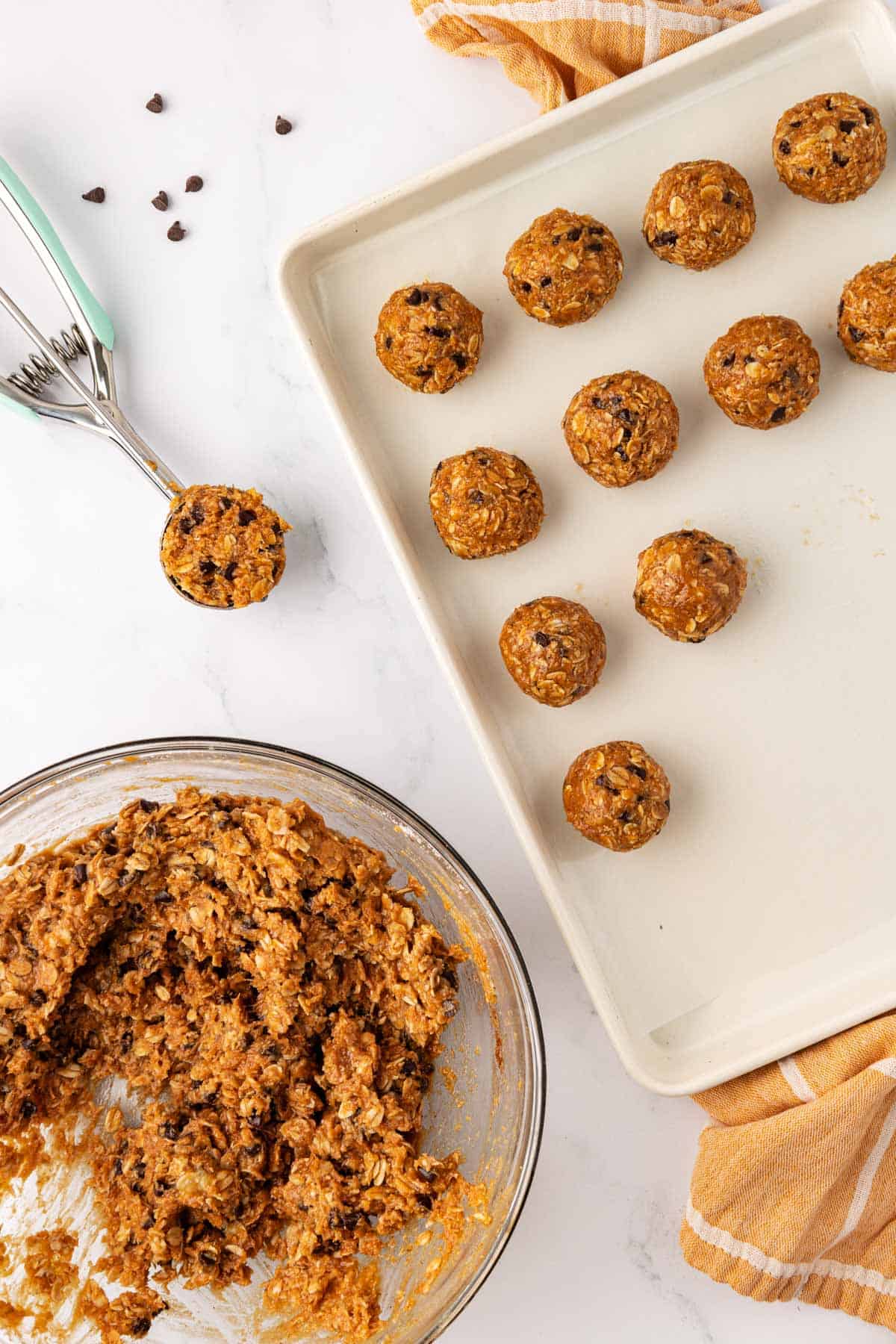 baking sheet with a scoop and energy bites