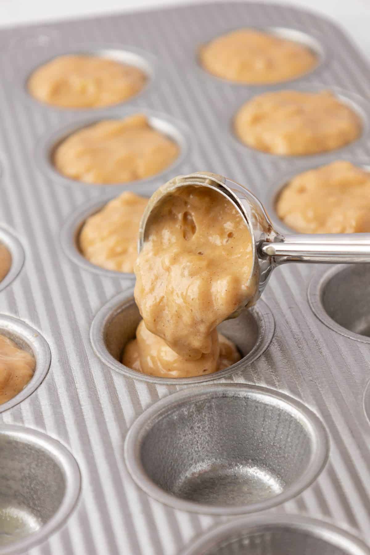 pouring the muffin batter into a mini muffin tin