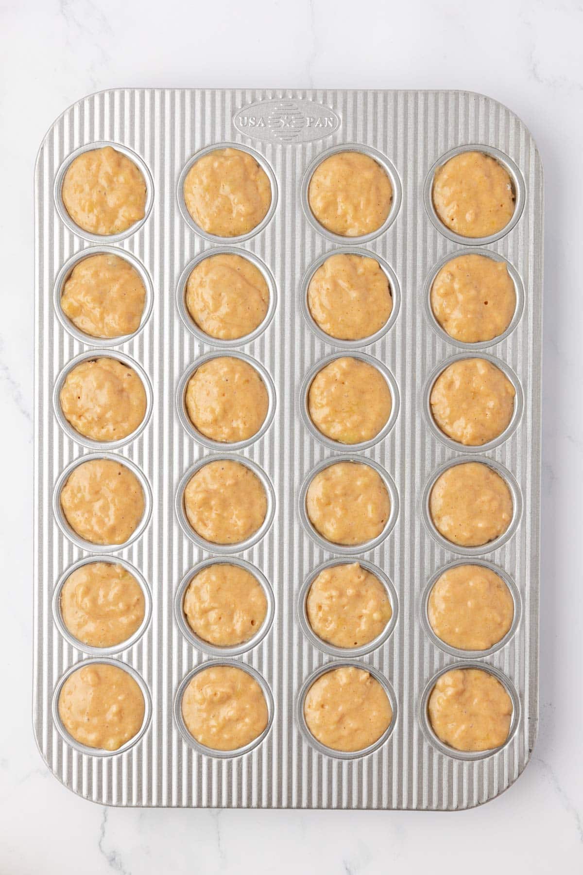 mini muffin tin filled with batter
