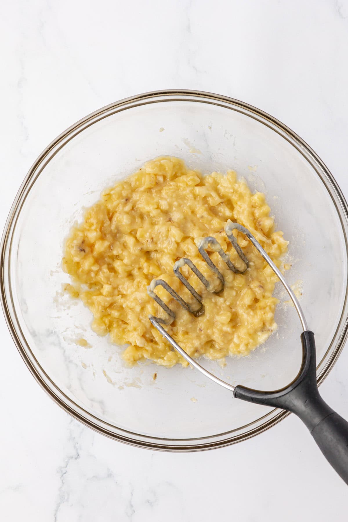 mashed bananas in a mixing bowl