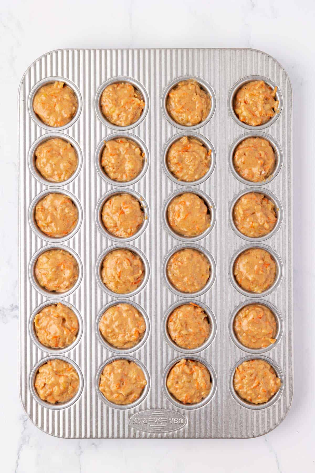 ABC mini muffin batter in a muffin tin