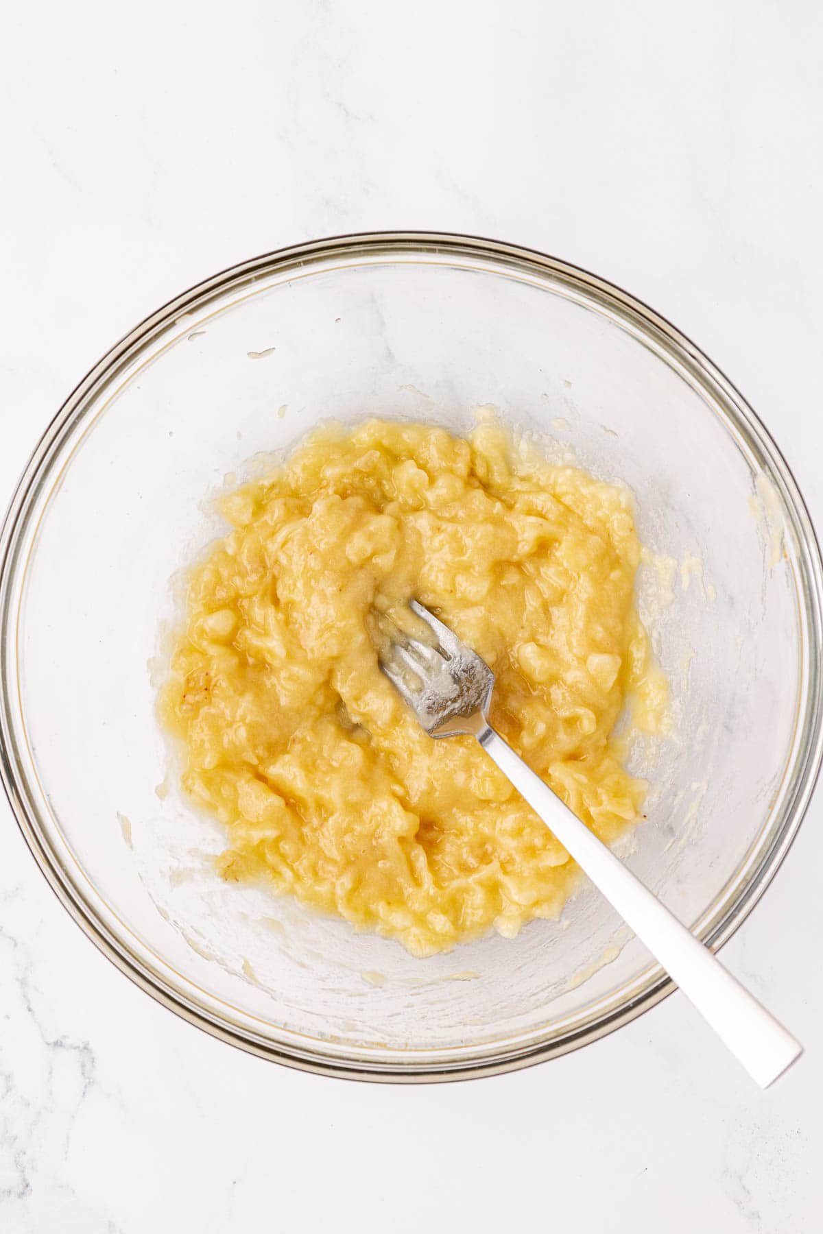 mashed banana in a mixing bowl