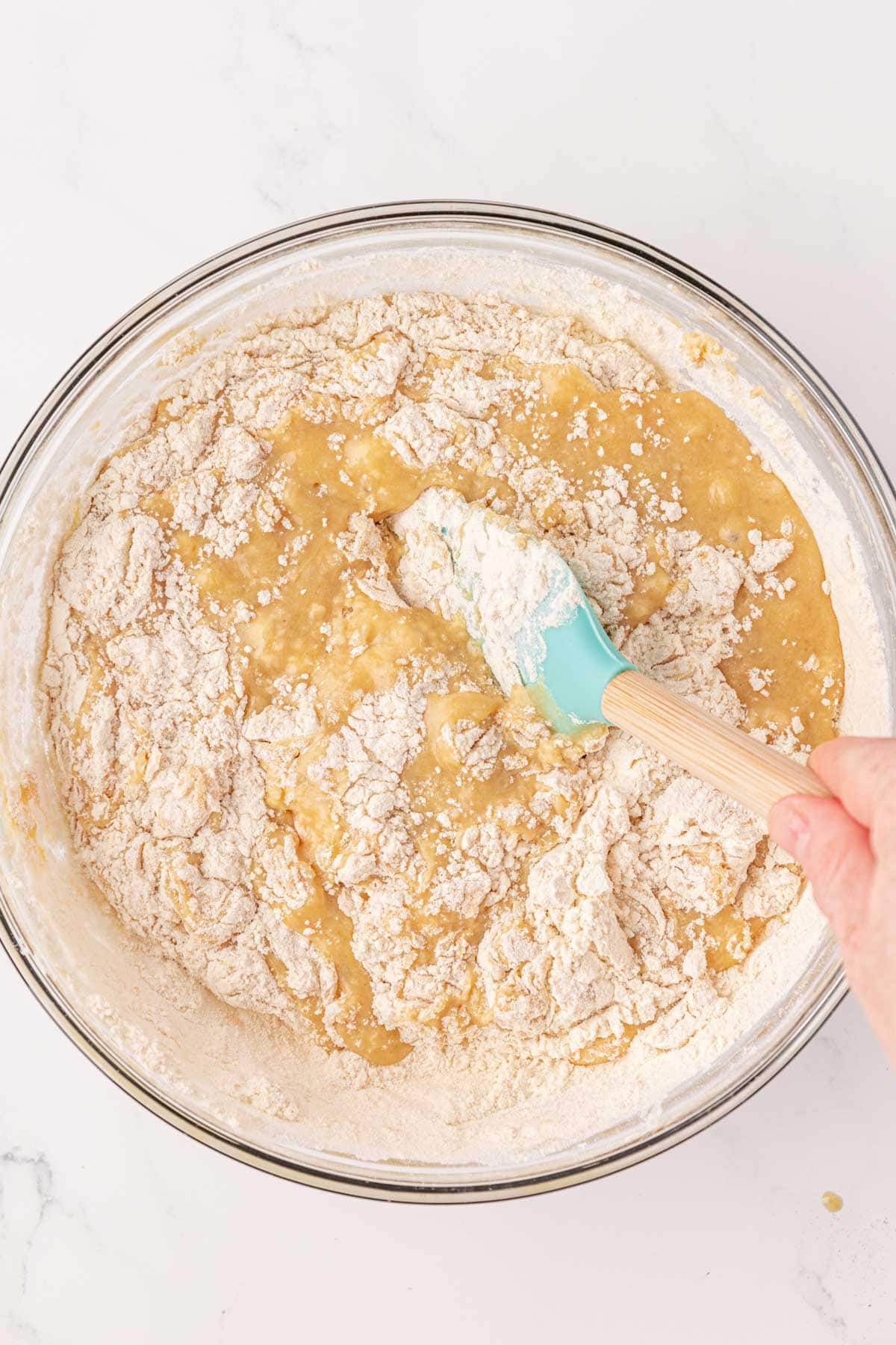 stirring the dry ingredients into the wet ingredients