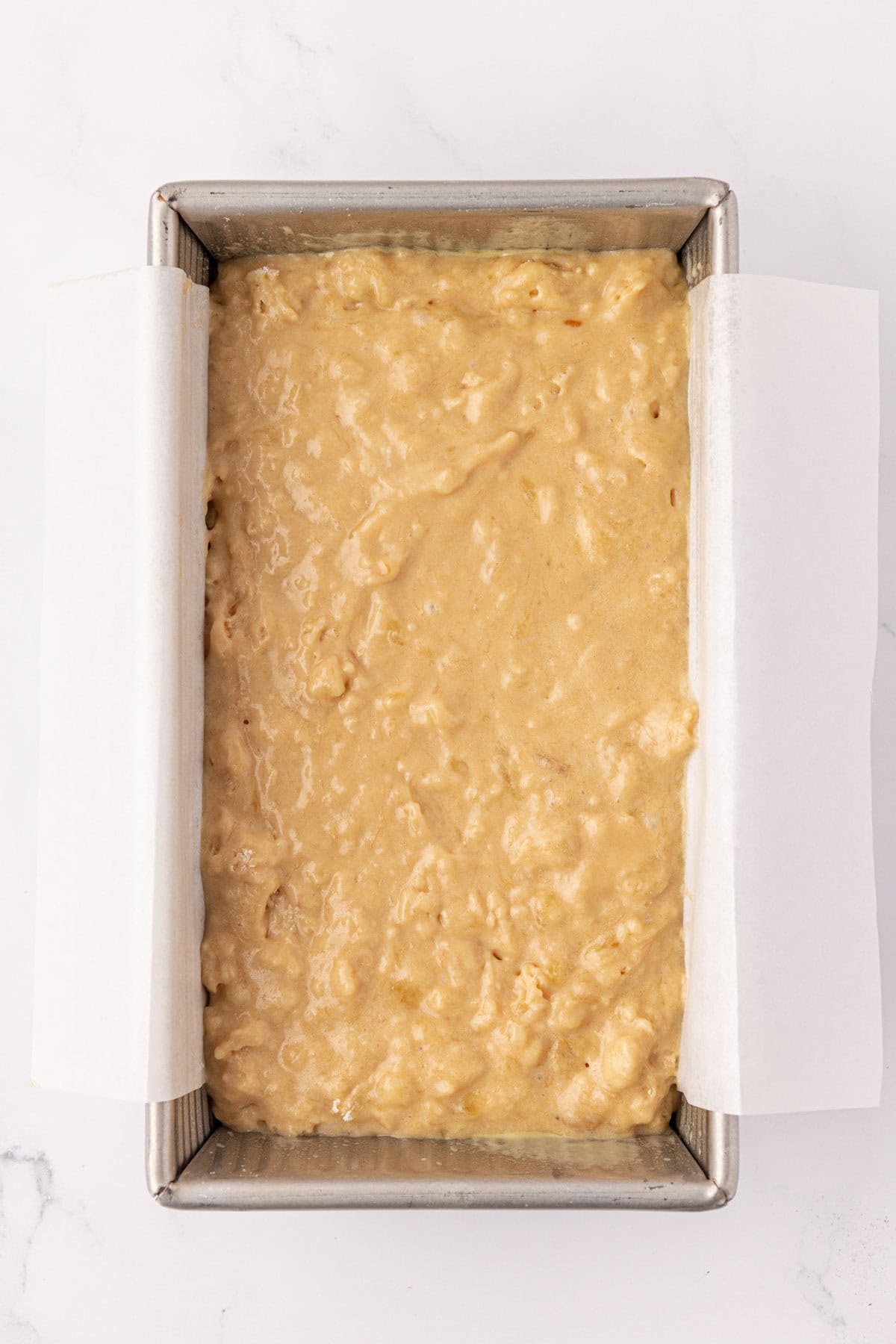 greek yogurt banana bread batter in a loaf pan