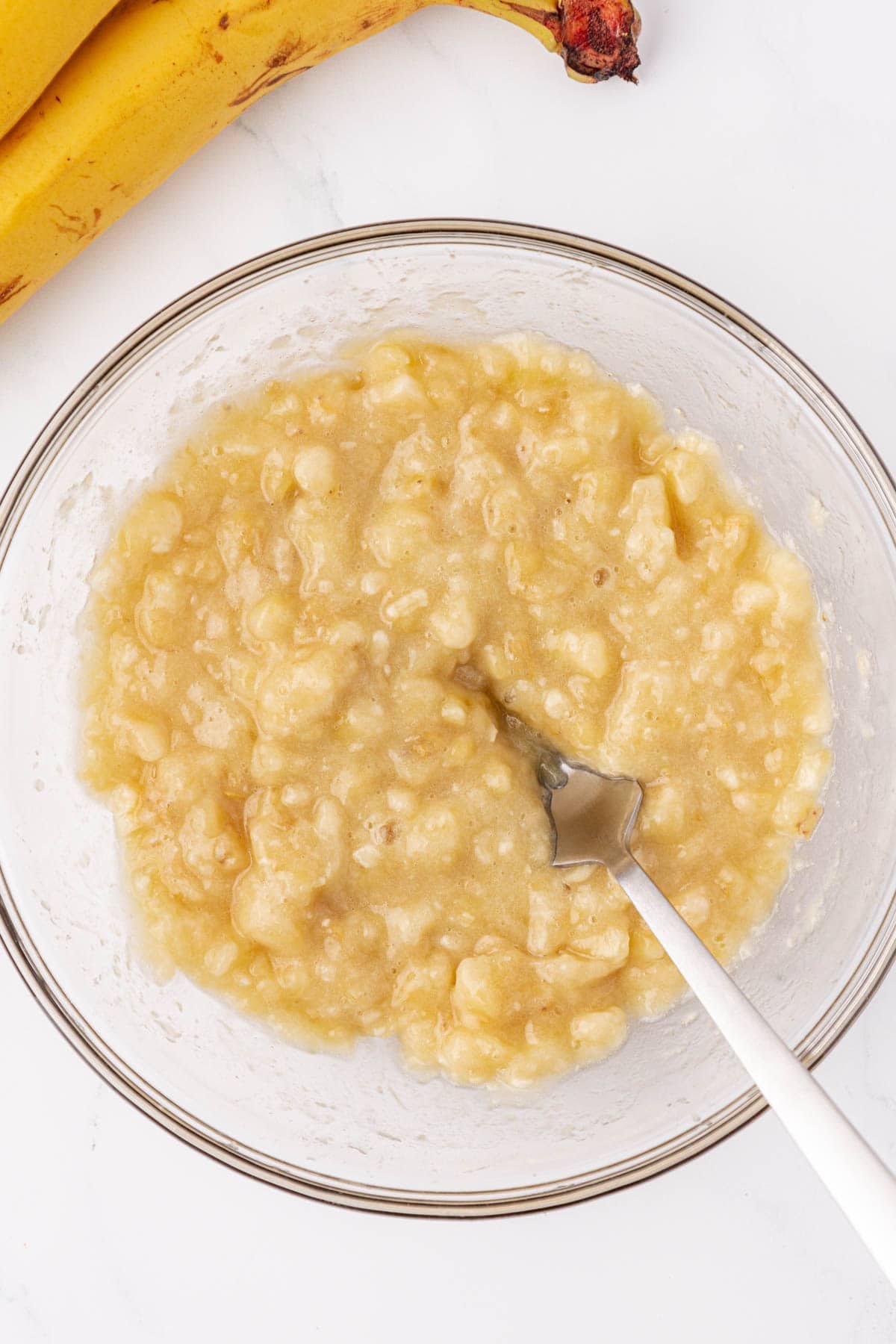 mashed banana in a mixing bowl