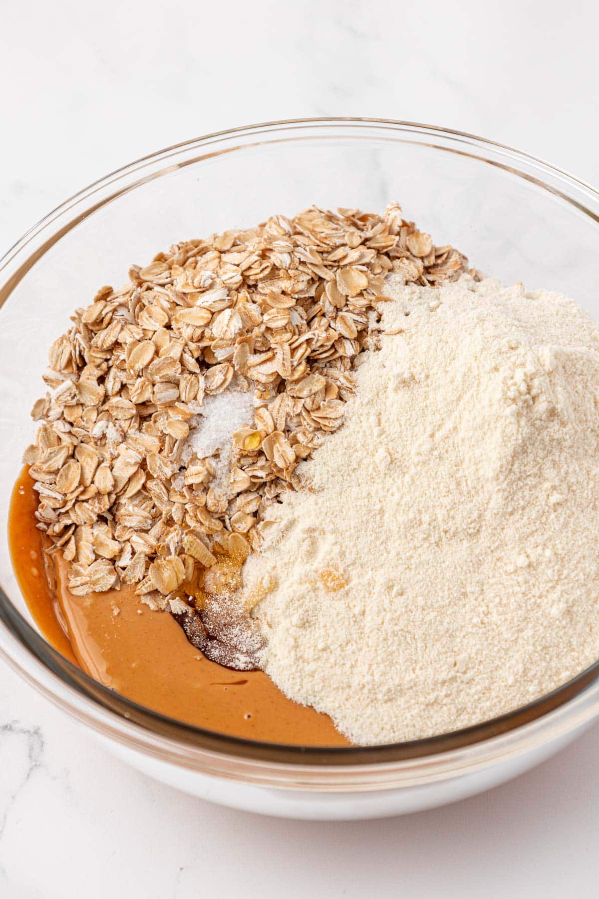adding the honey, protein powder, salt, and oats