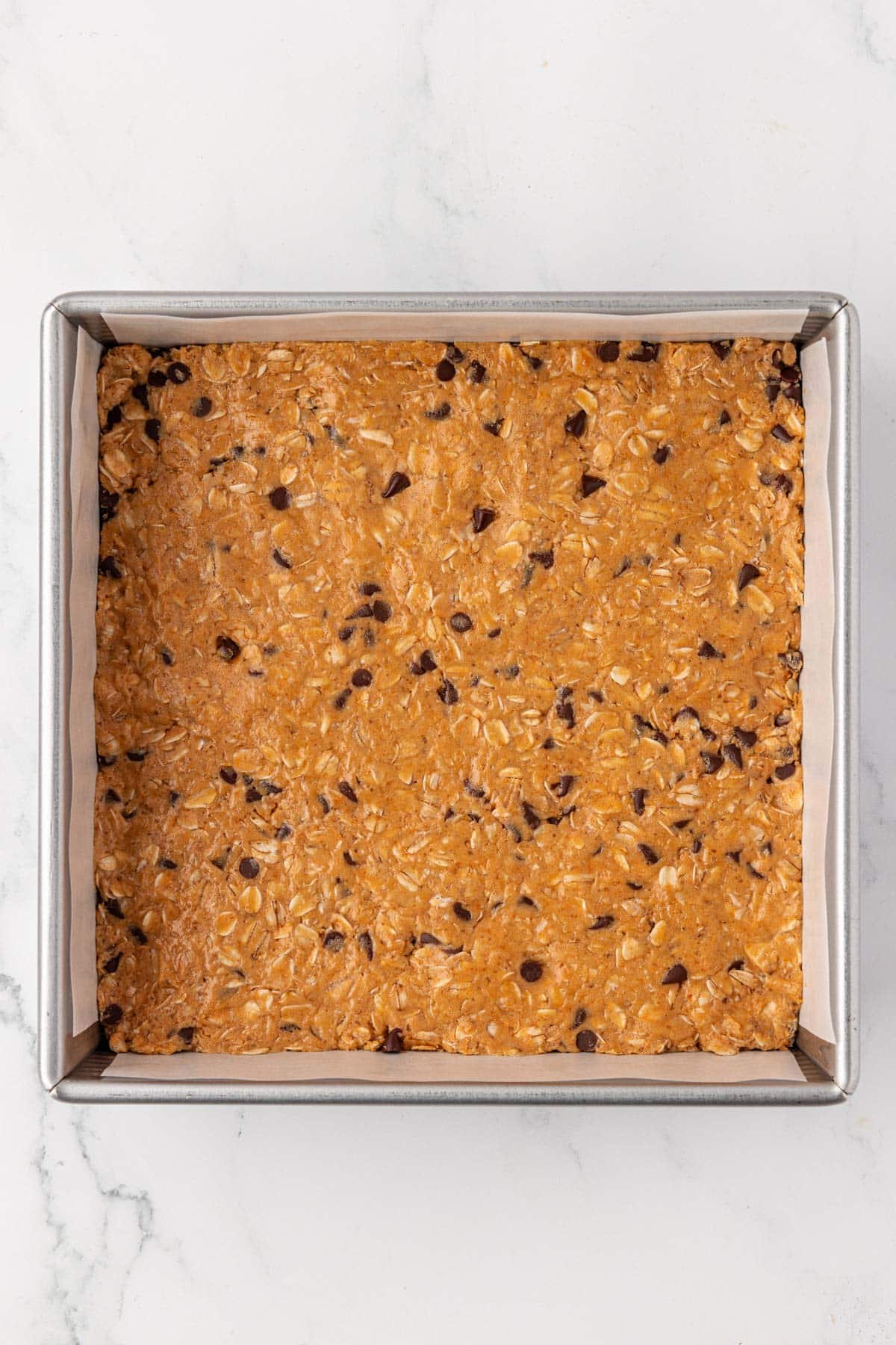 protein granola bar batter pressed into a pan