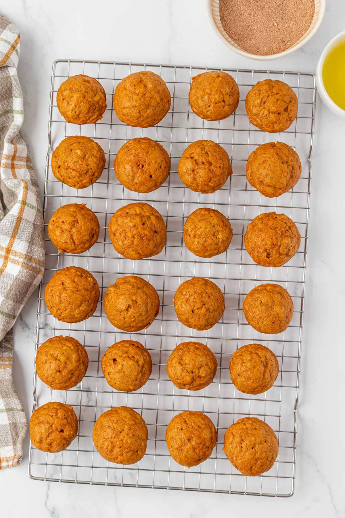 pumpkin donut mini muffins on a cooling rack