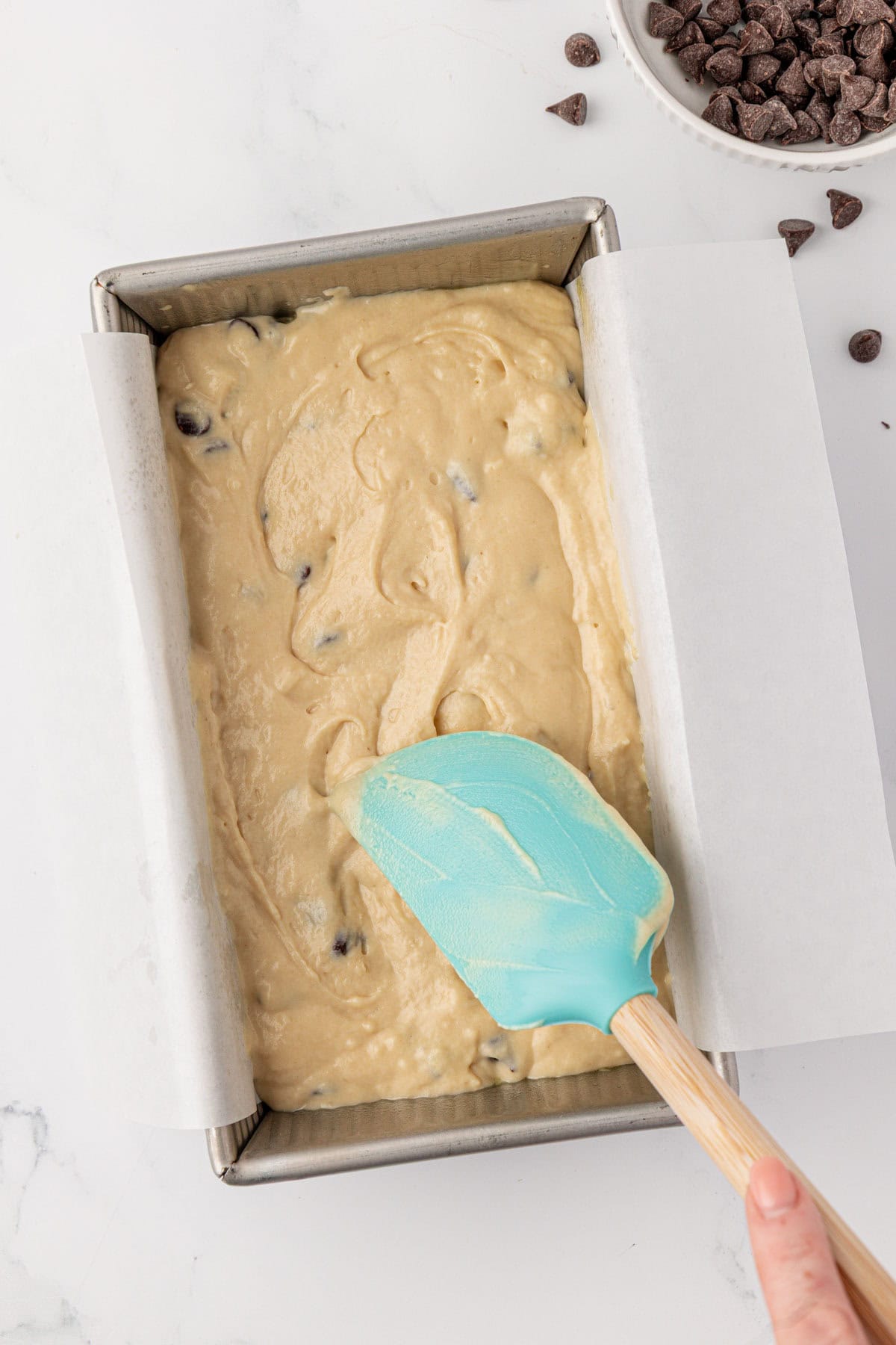 spreading the batter into a loaf pan