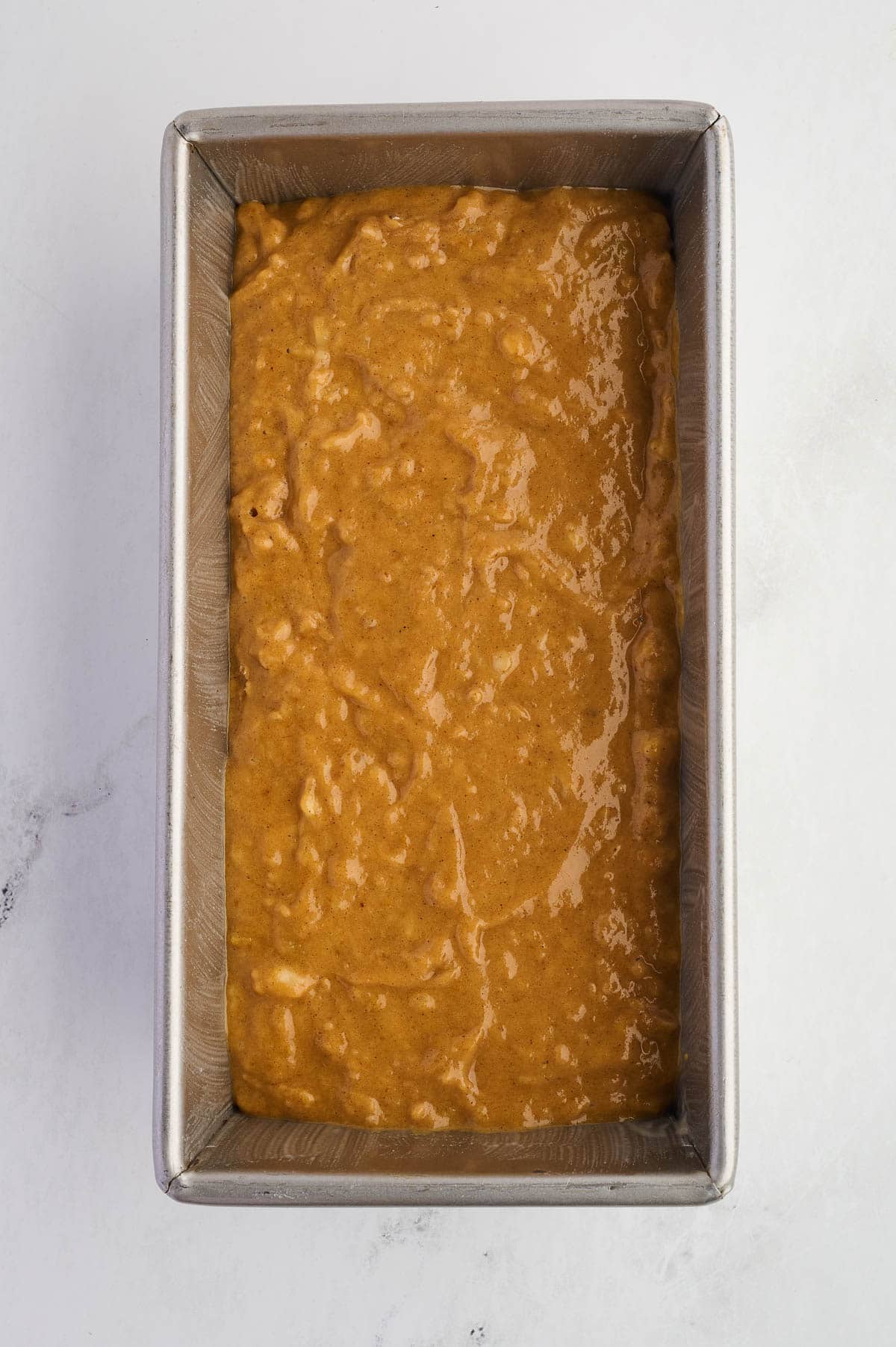 pumpkin banana bread batter in a loaf pan
