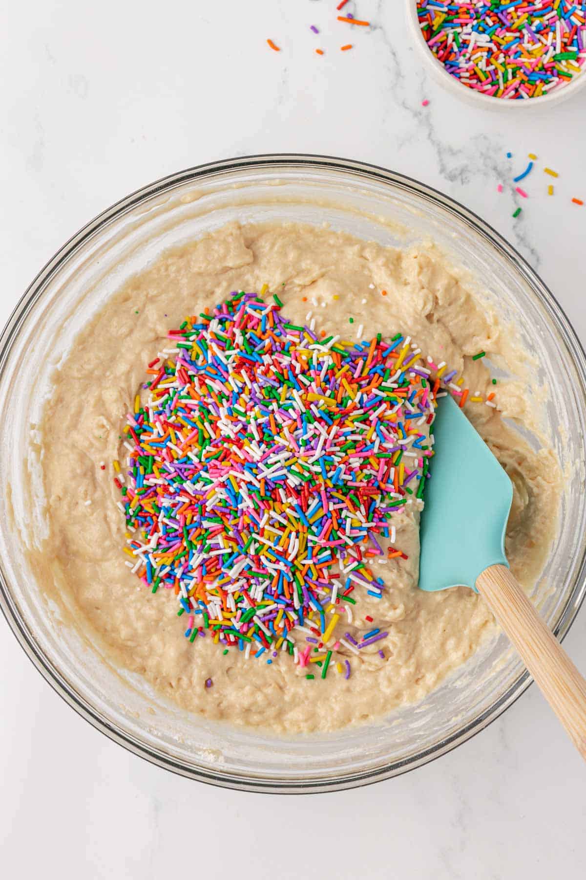 folding the sprinkles into the batter