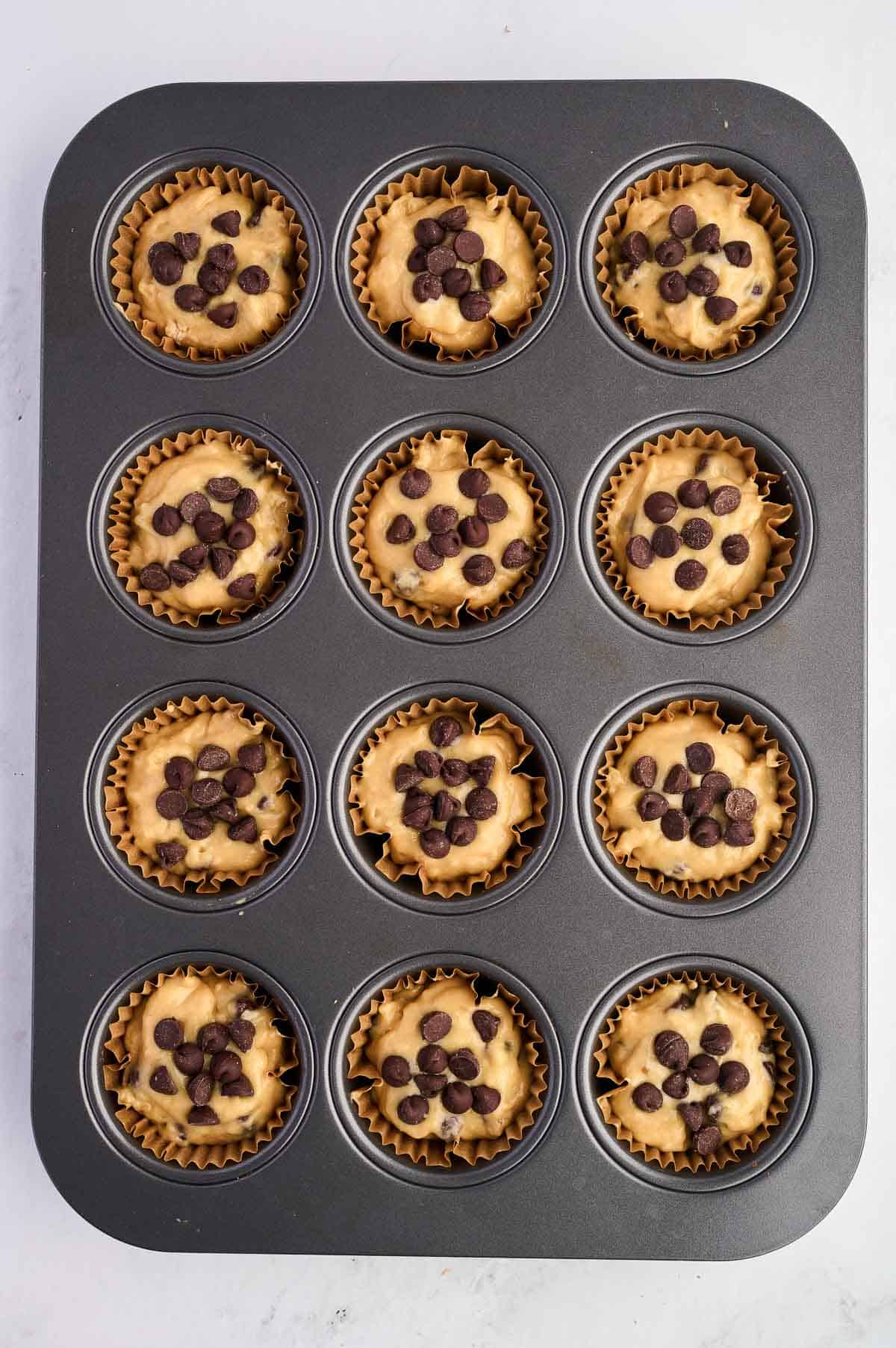 muffin batter in a muffin tin