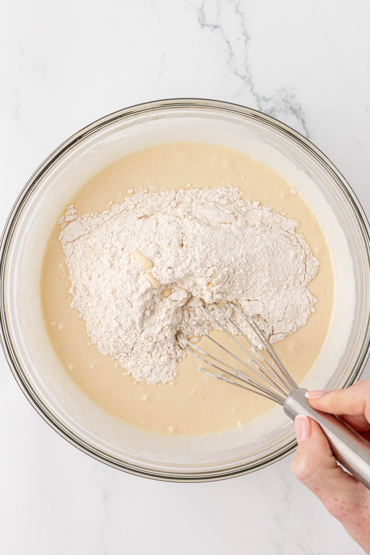 whisking the dry ingredients into the wet ingredients